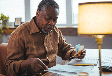 man sitting at a desk looking at papers