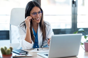 healthcare professional at a computer