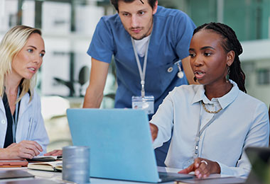 group of people sitting around a computer